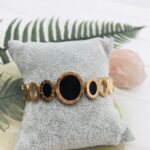Gold Watch Bracelet with a Black Stone Face 1